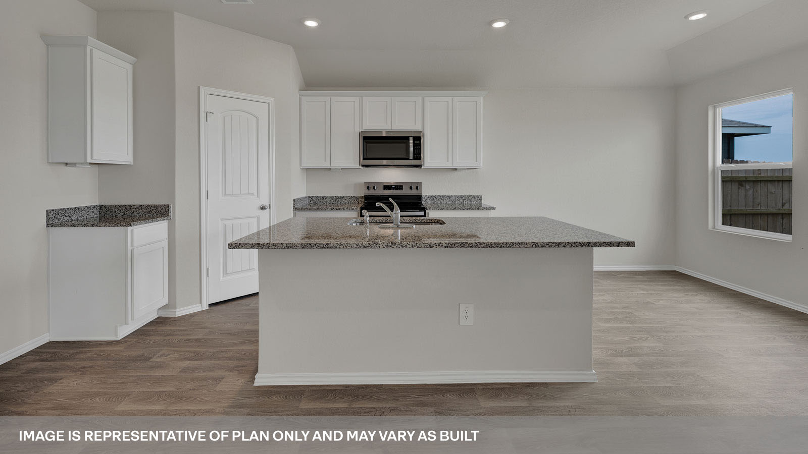 Kitchen with kitchen island and granite countertops.