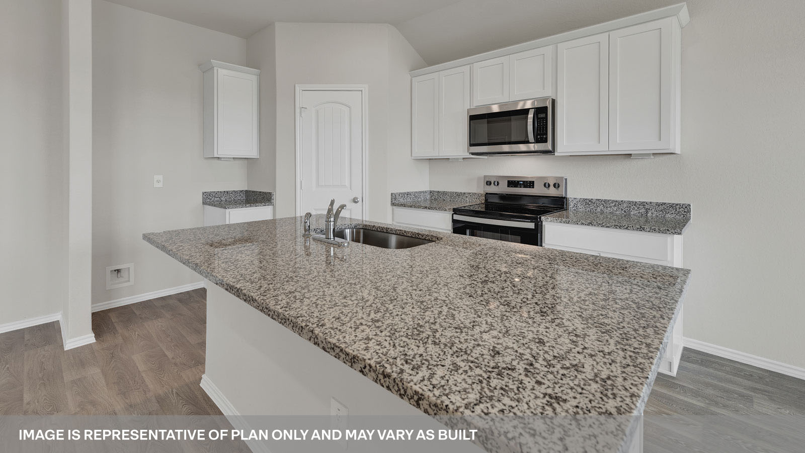 Kitchen with kitchen island and granite countertops.