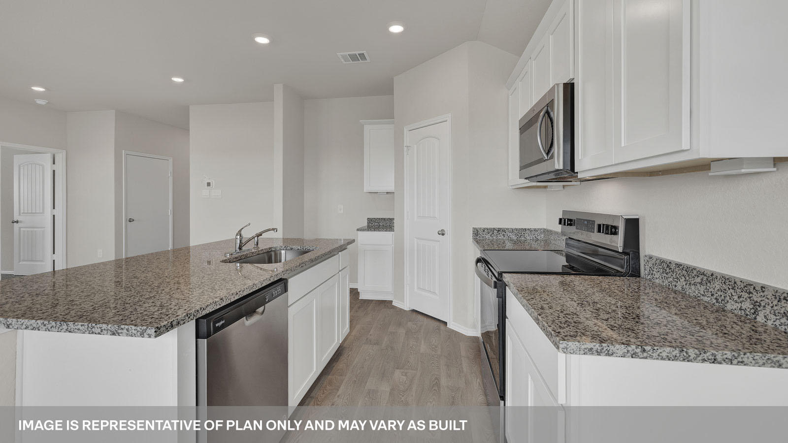 Kitchen island with granite countertops and large kitchen sink.