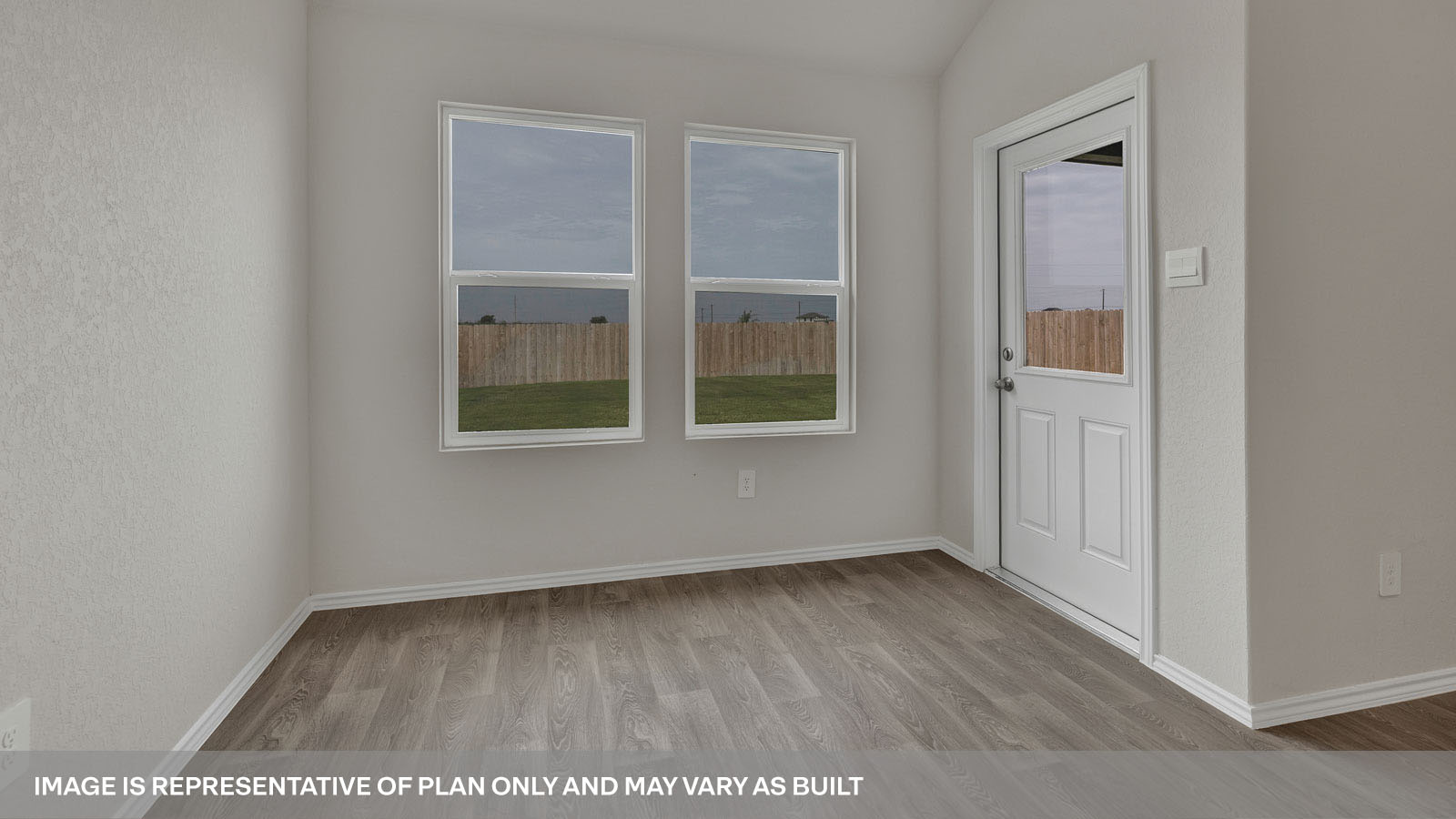 Dining room with vinyl flooring, 2 windows, and a half lite exterior door.