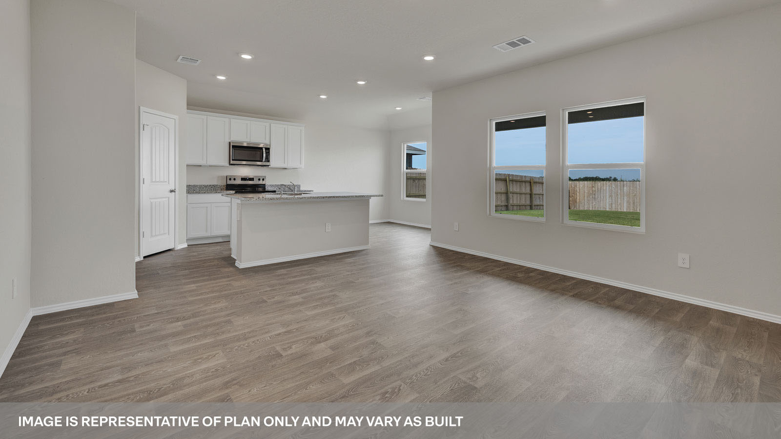 Living room opening to the kitchen with kitchen island.