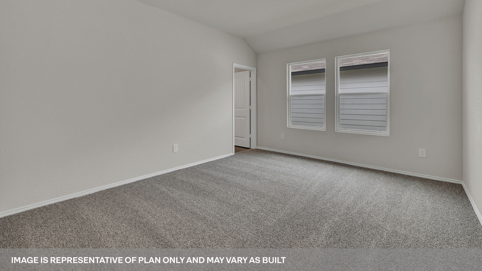 Main bedroom with carpeting and 2 windows.