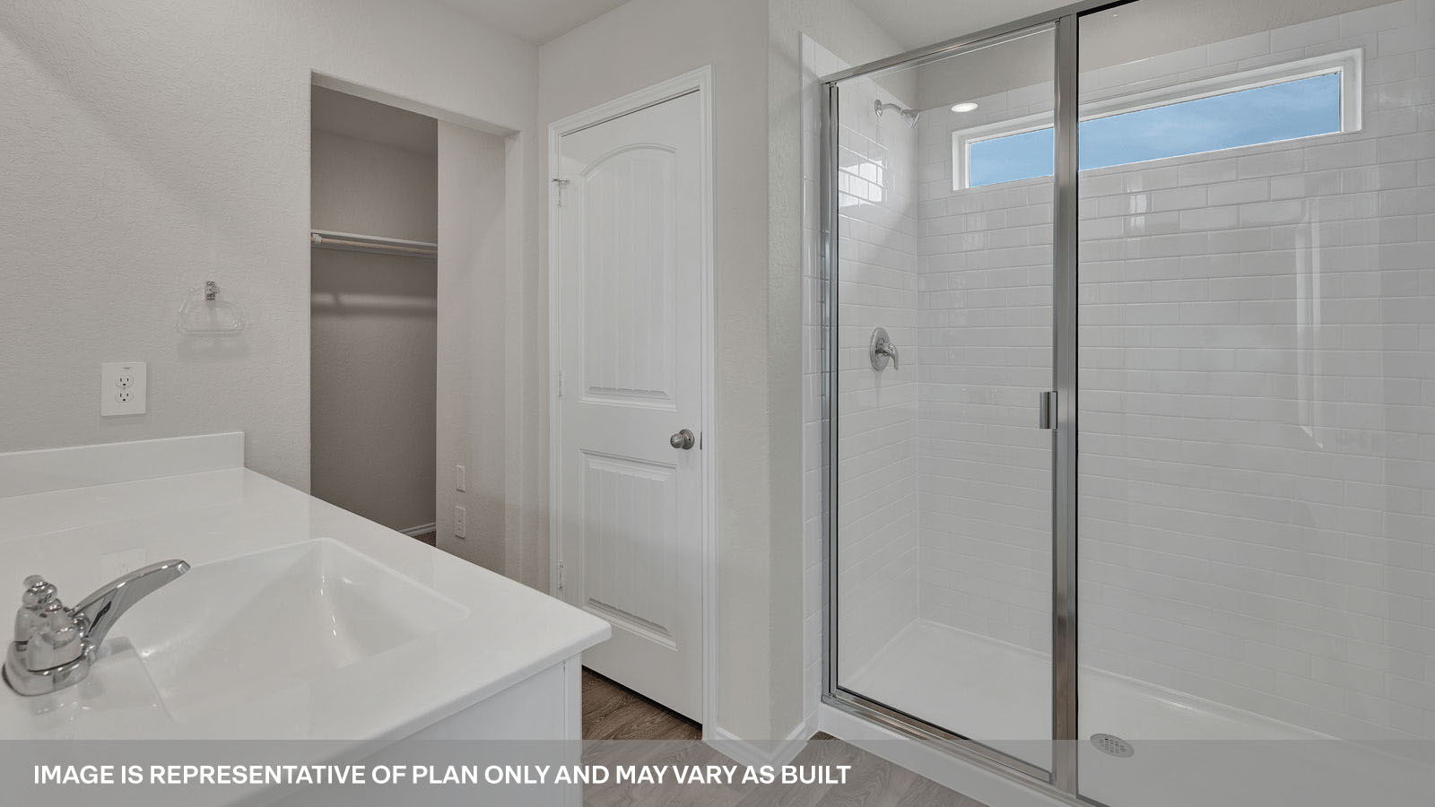 Main bathroom withwalk-in shower and vanity.