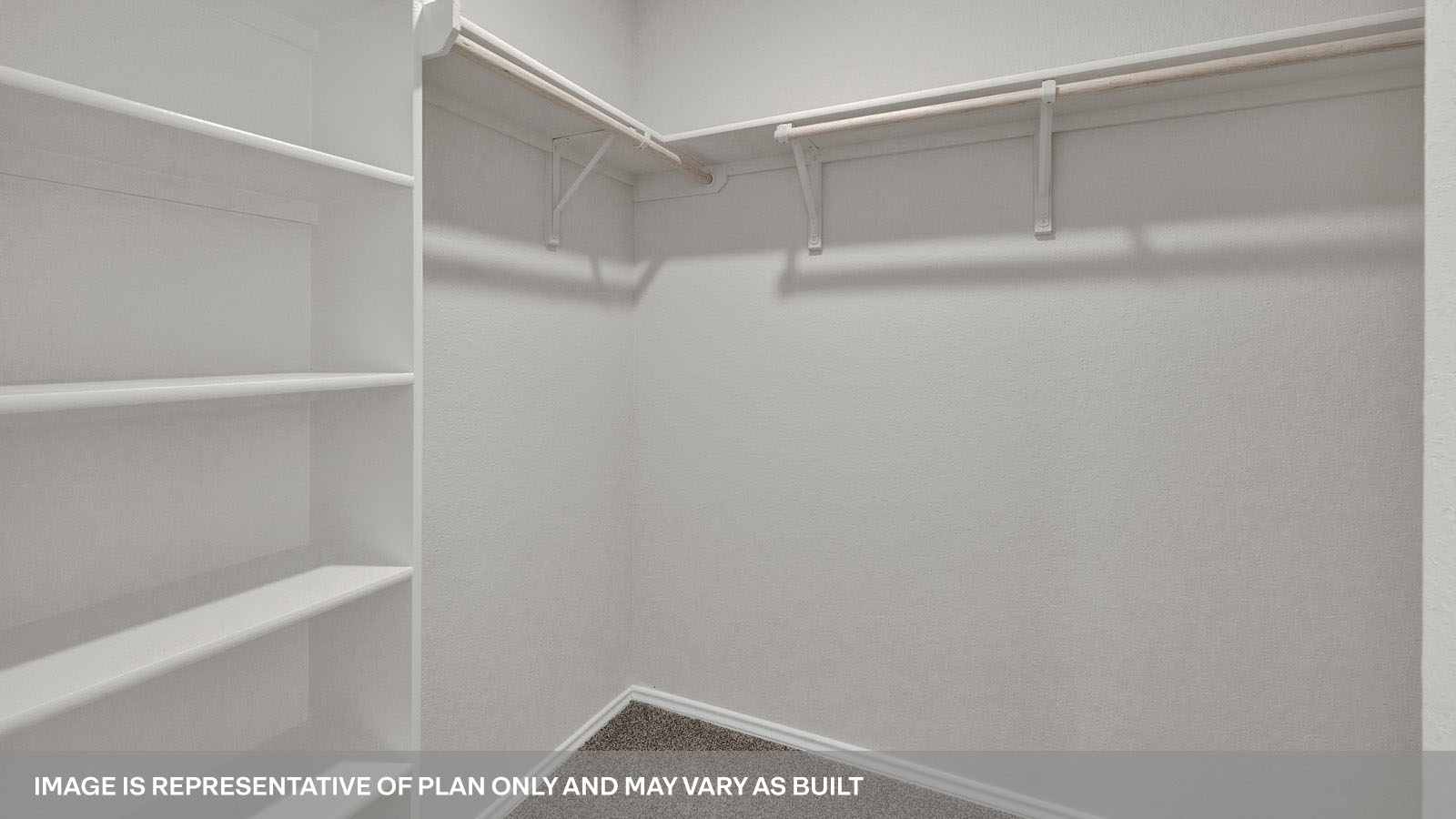 Main bedroom closet with carpeting and wooden shelving.