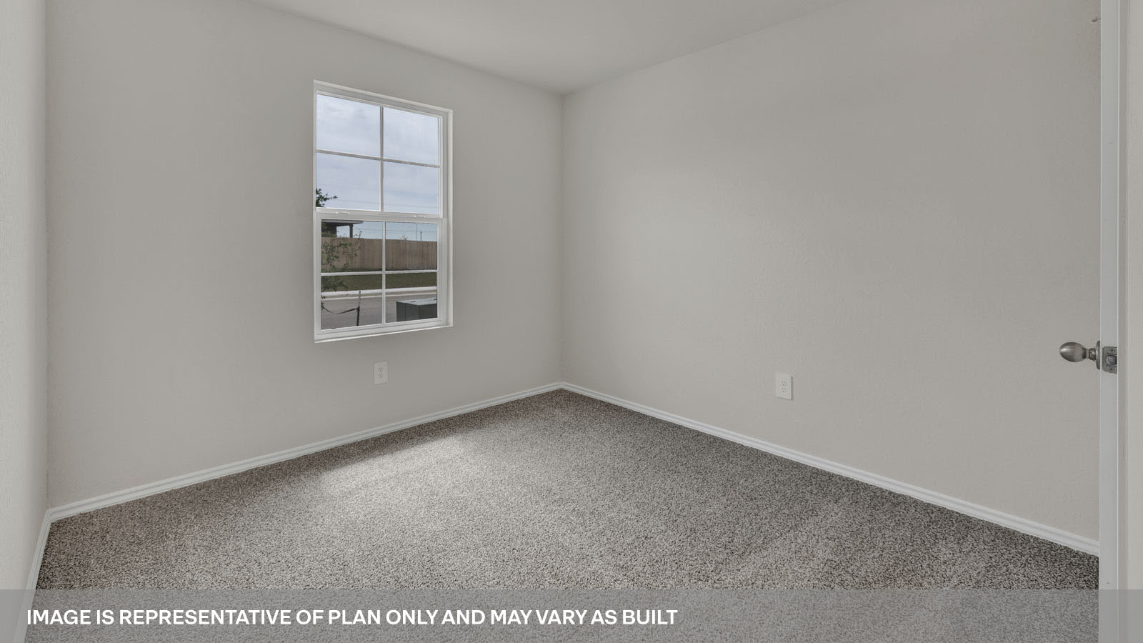 Front bedroom with carpeting and one window.
