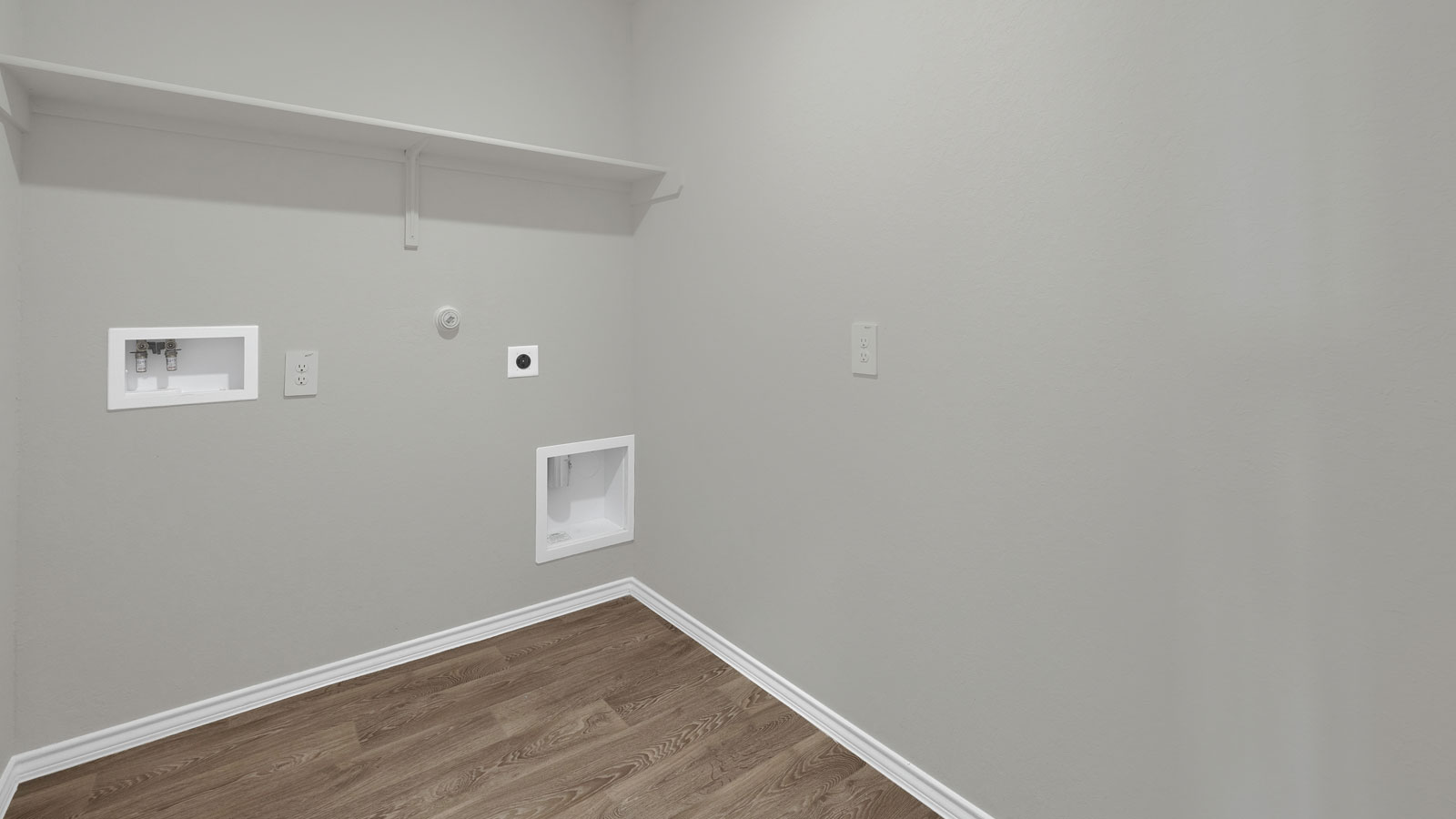 Laundry room with washer/dryer connections and wooden shelving.