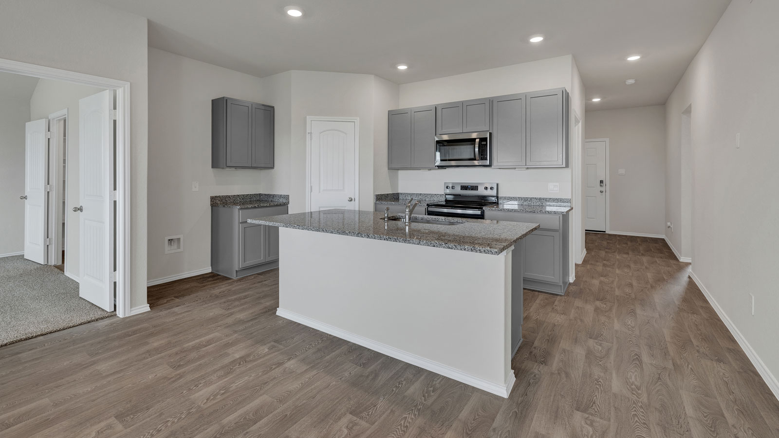 Kitchen with kitchen island and grey cabinets.