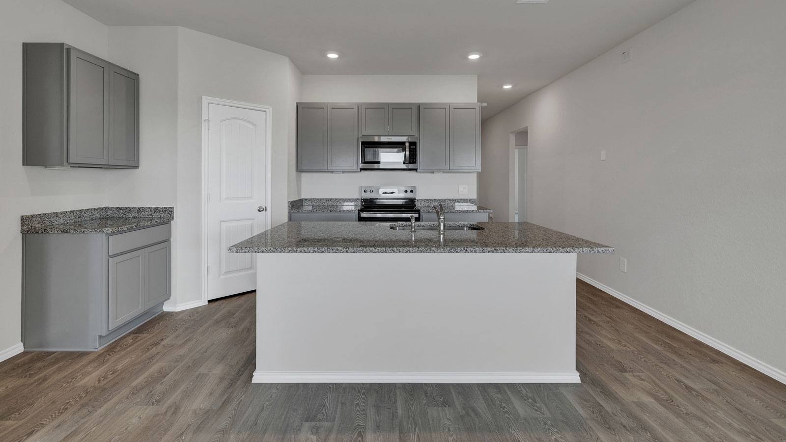 Kitchen with kitchen island and grey cabinets.