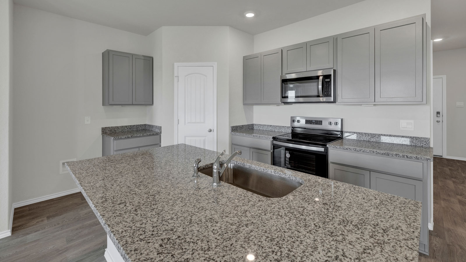 Kitchen with kitchen island and granite countertops.
