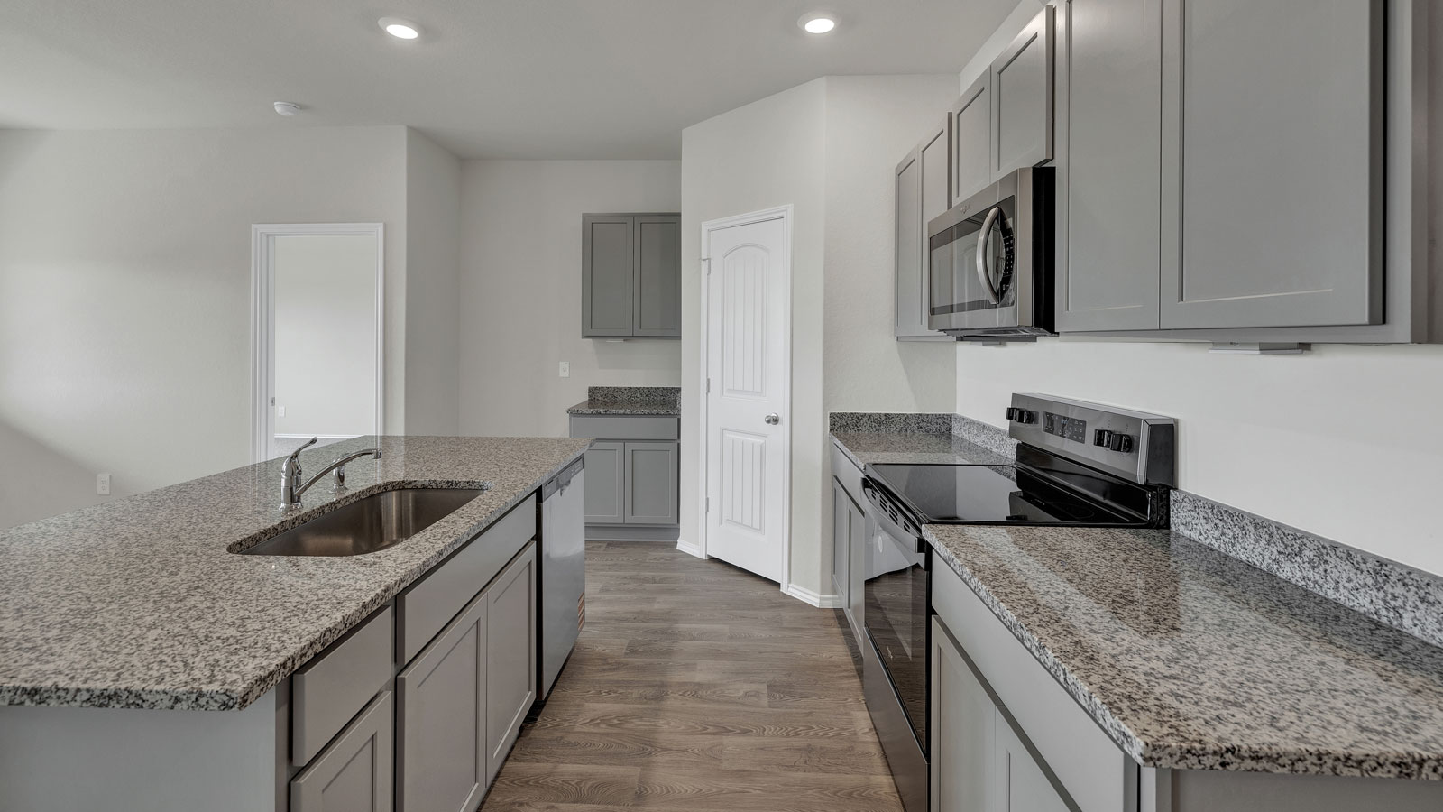 Kitchen with kitchen island and granite countertops.