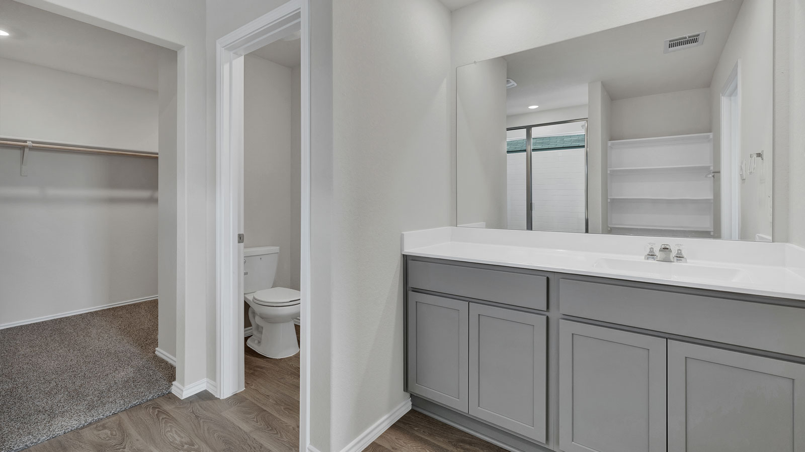 Main bathroom with vanity and water closet.
