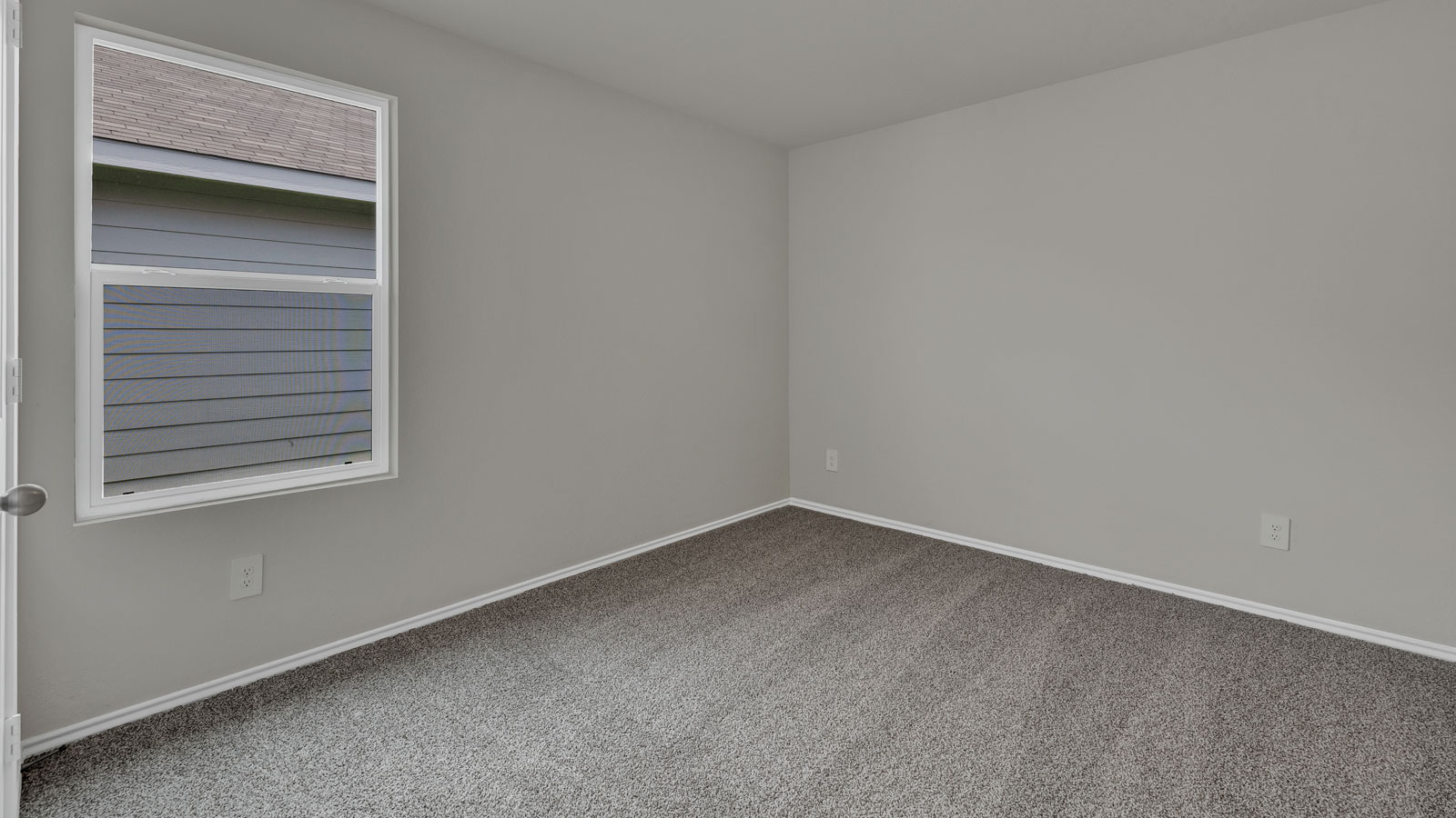 Bedroom with carpeting and one window.