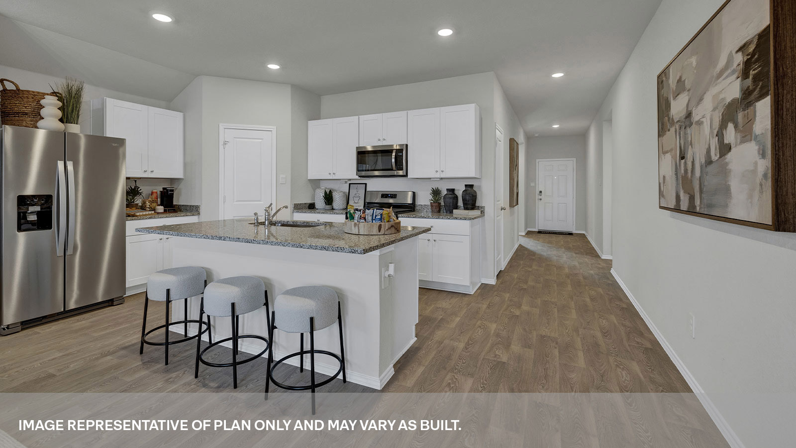 Kitchen with kitchen island and entry hallway.