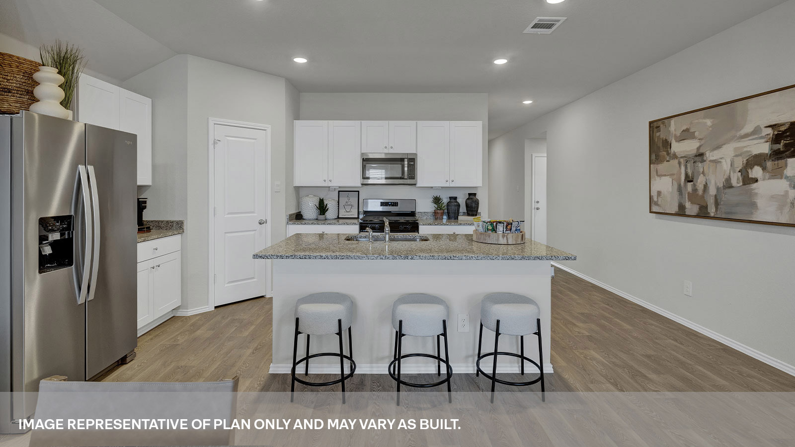 Kitchen with kitchen island and entry hallway.