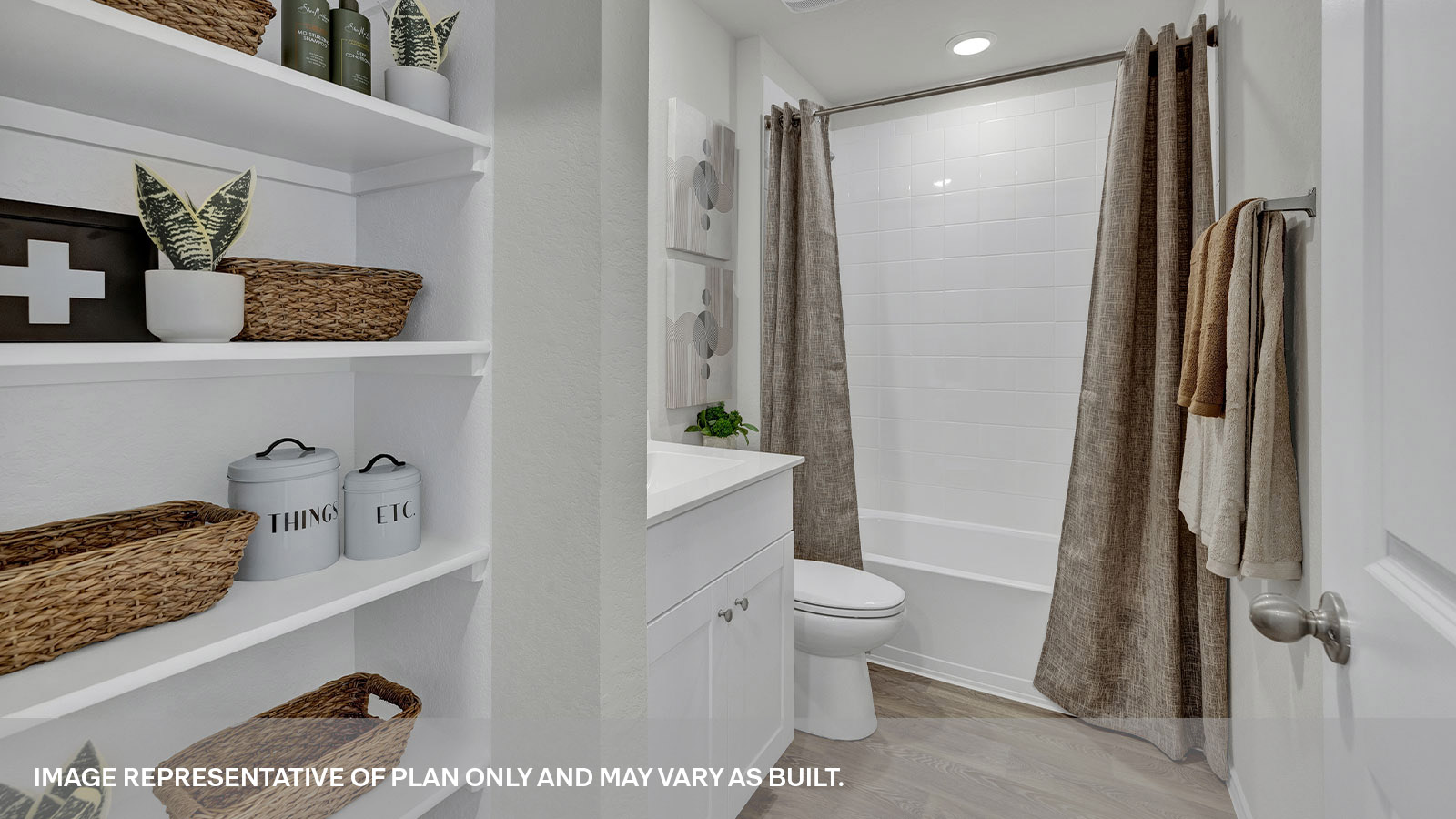 Hall bathroom with wooden shelving, toilet, and tub.