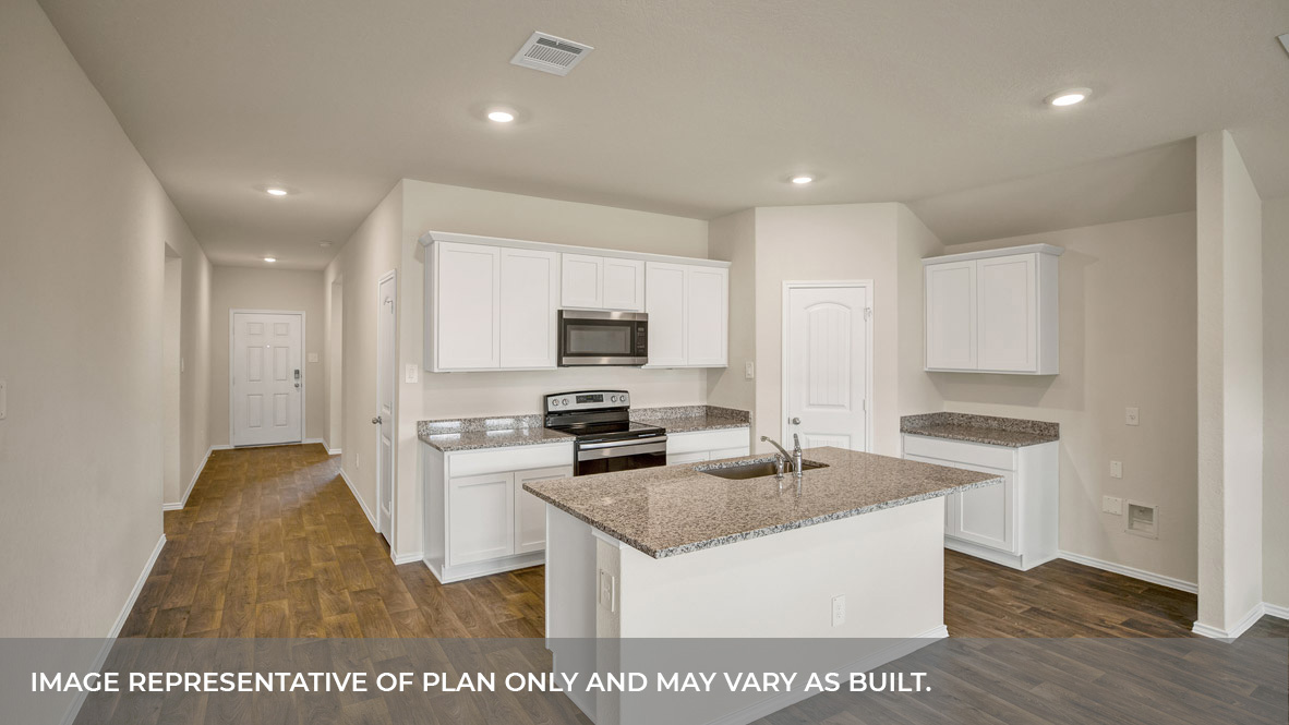 Kitchen with kitchen island and entry hallway.