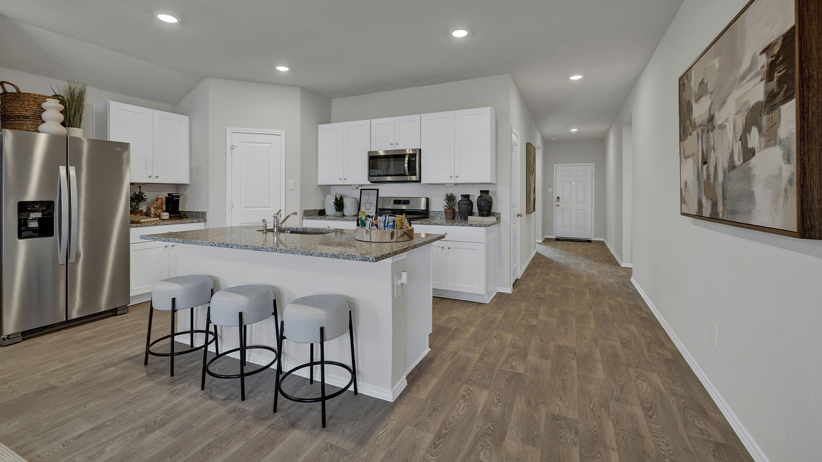 Kitchen with kitchen island and entry hallway.