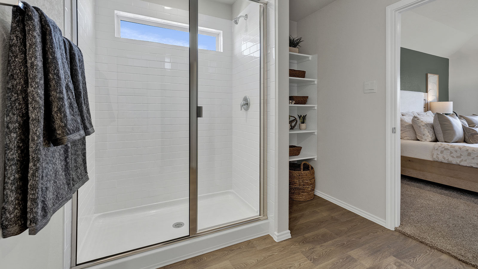 Main bathroom with wooden shelving, vanity, and walk-in shower.