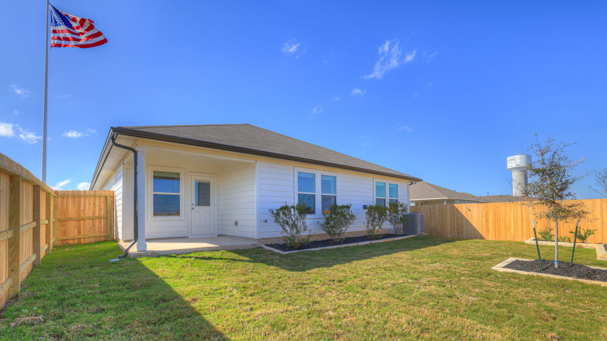 Covered patio with fully sodded backyard and privacy fence.