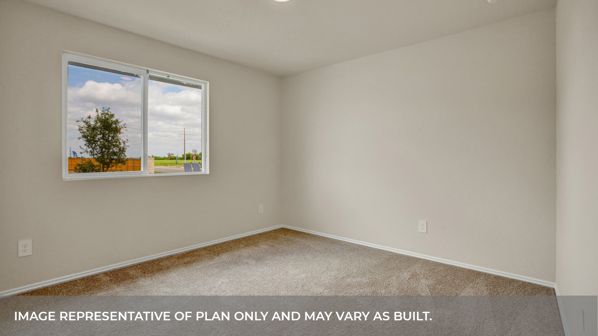 Front bedroom with carpeting and two windows.