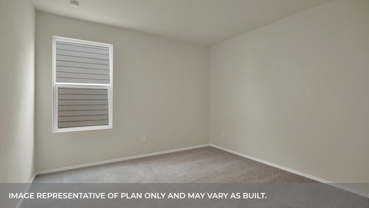 Bedroom with carpeting and one window.