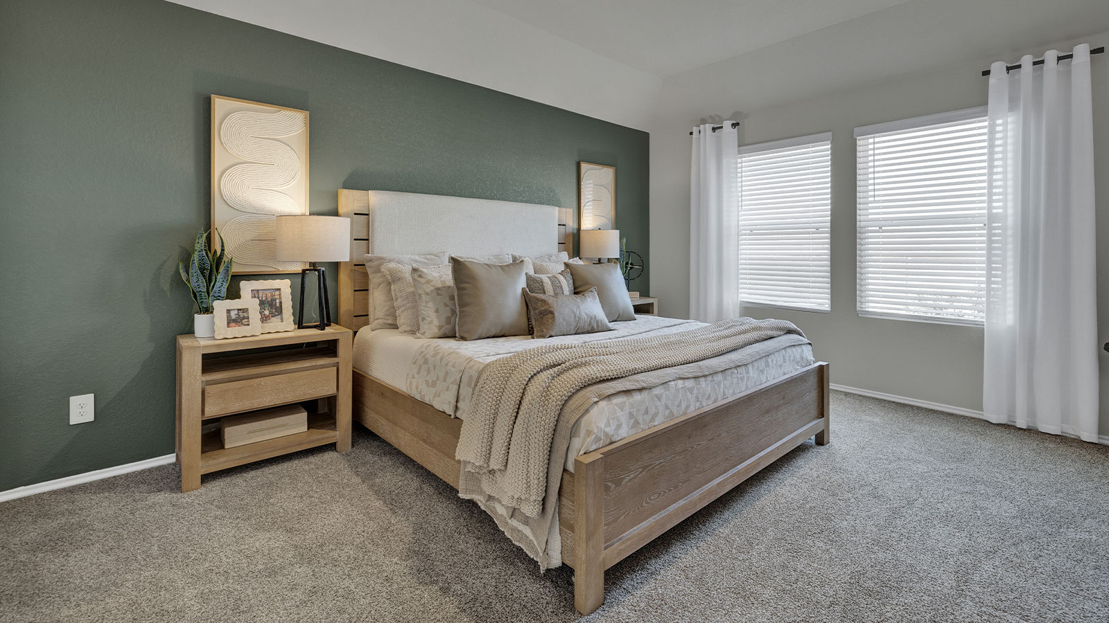 Main bedroom with carpeting and two windows.