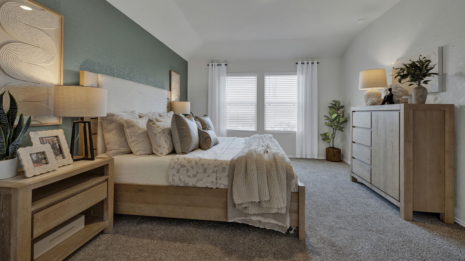 Main bedroom with carpeting and two windows.