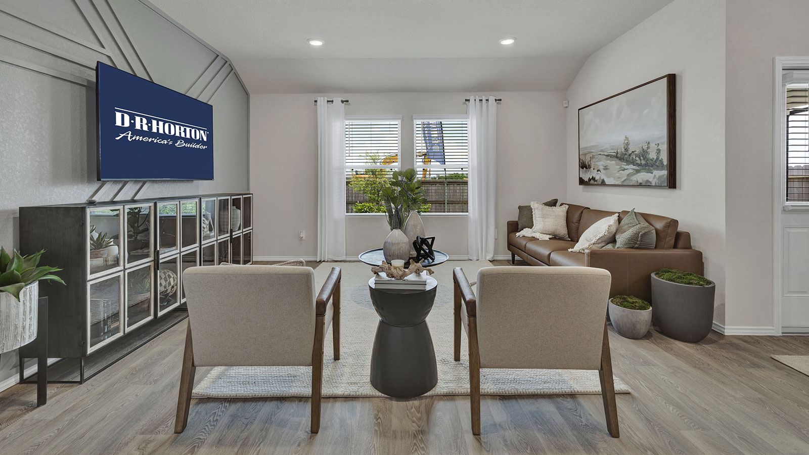 Living room with vinyl flooring and two windows.