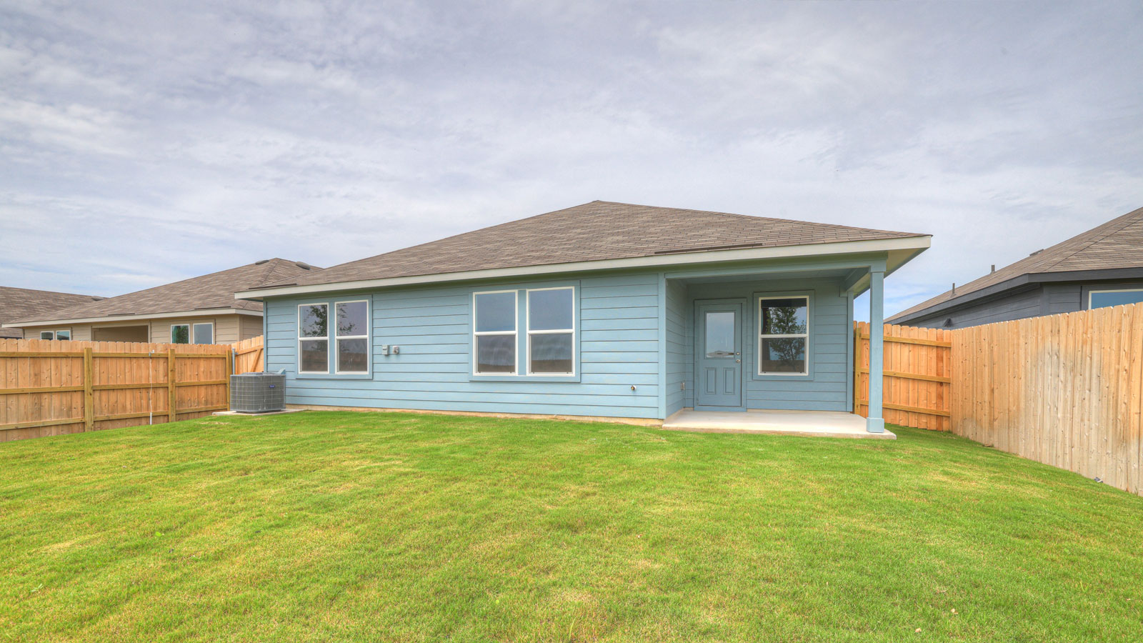 Covered patio with fully sodded backyard and privacy fence.