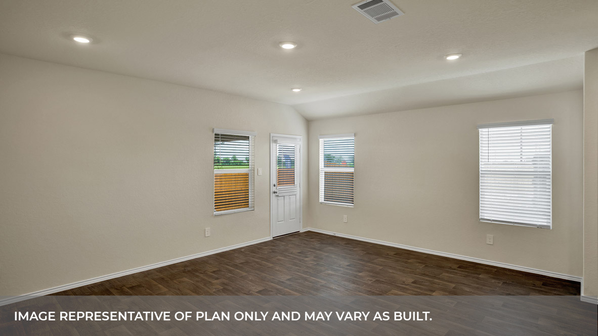 Living room with vinyl flooring, 3 windows, and half lite exterior door.