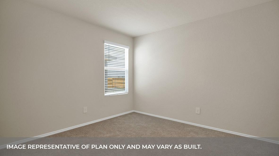 Bedroom with carpeting and one window looking into the side yard.