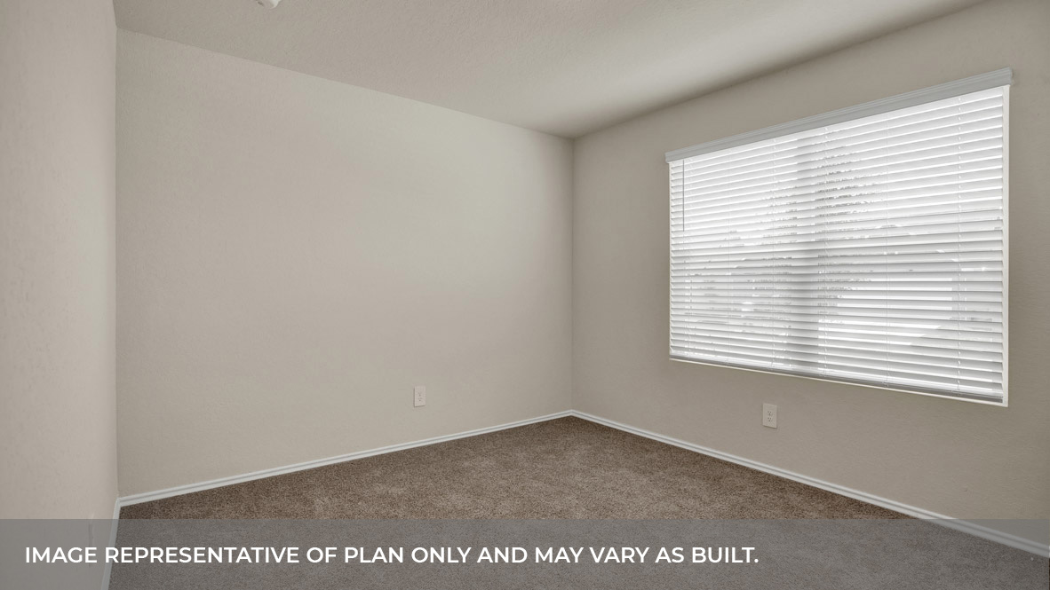 Front bedroom with carpeting and two windows.