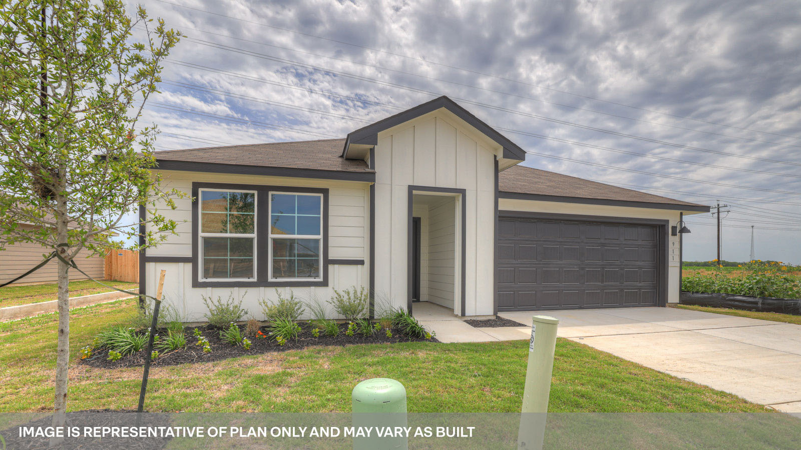 Single-story farmhouse exteriors with one windows and 2 garage door.