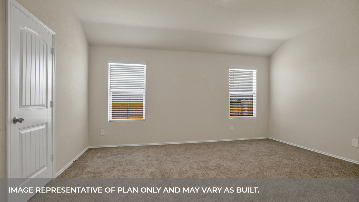 Main bedroom with carpeting and two windows.