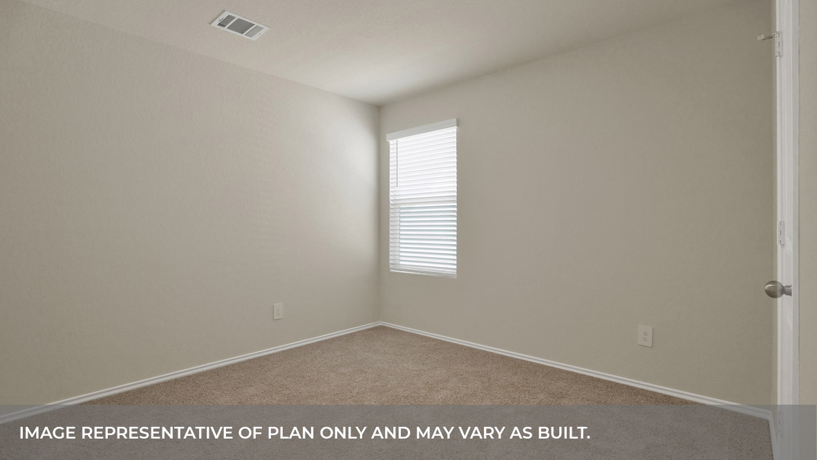 Bedroom with carpeting and one window looking into the side yard.