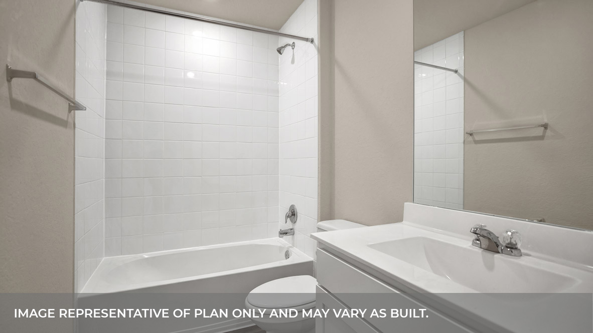 Hall bathroom with single sink vanity, toilet, and tub.