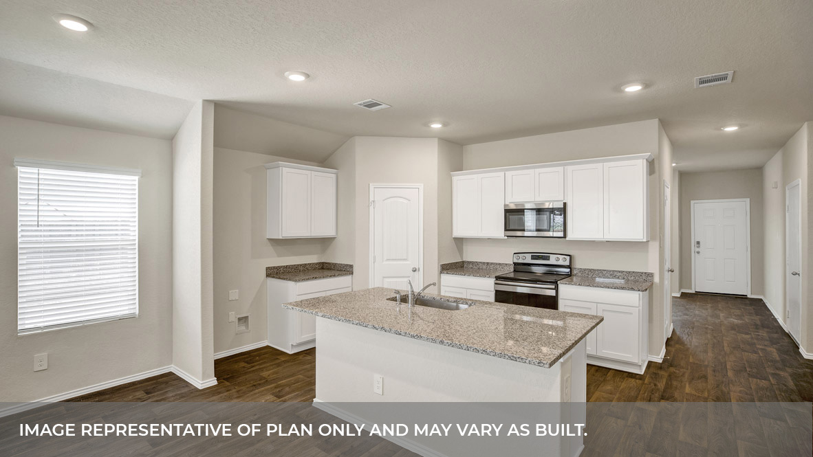 Kitchen with kitchen island and entry hallway.