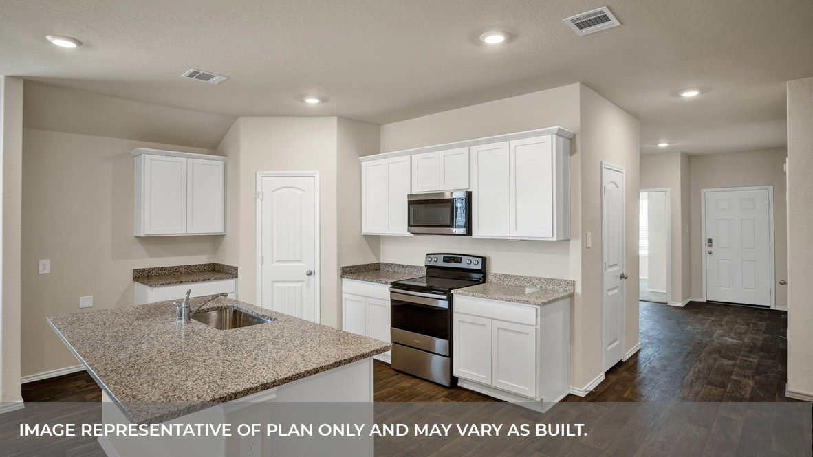 Kitchen with kitchen island and entry hallway.