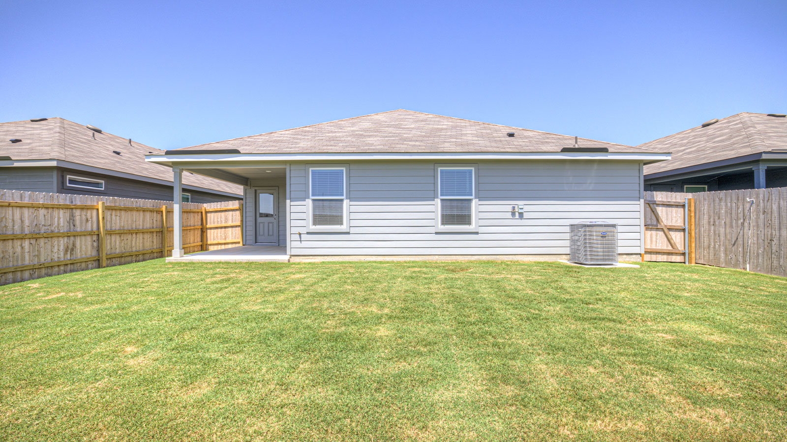Covered patio with fully sodded backyard and privacy fence.