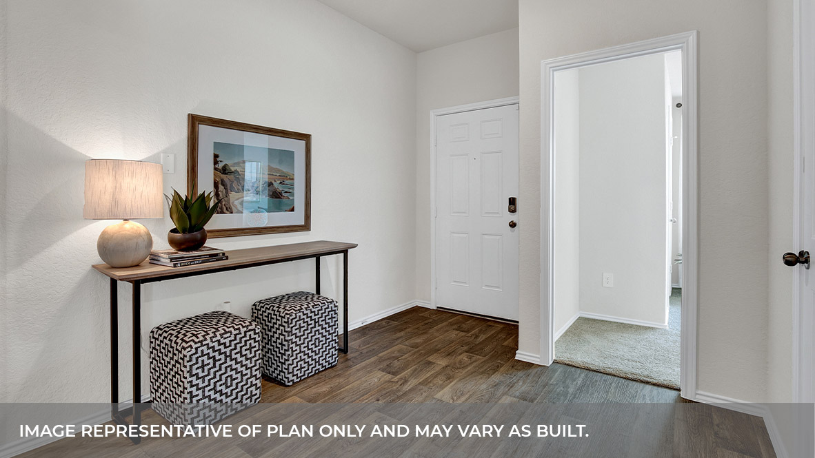 Entryway with vinyl flooring and front door.