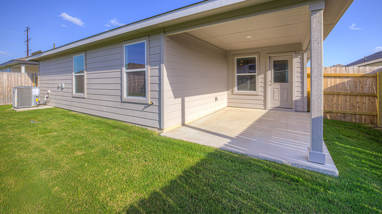 Covered patio with fully sodded backyard and privacy fence.