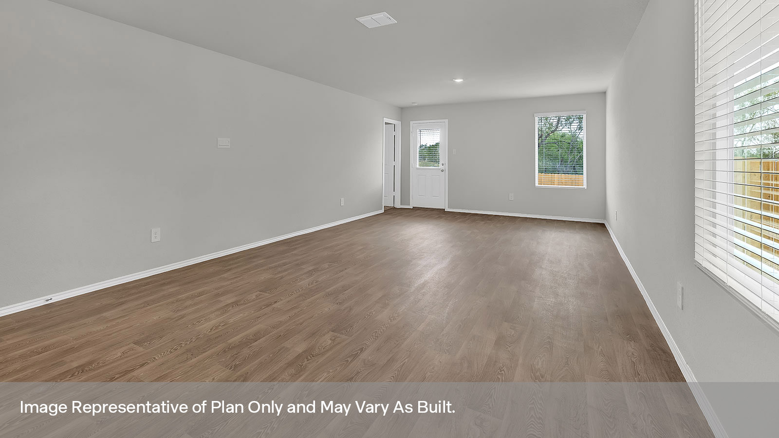 Dining room and living room with vinyl flooring and two windows.
