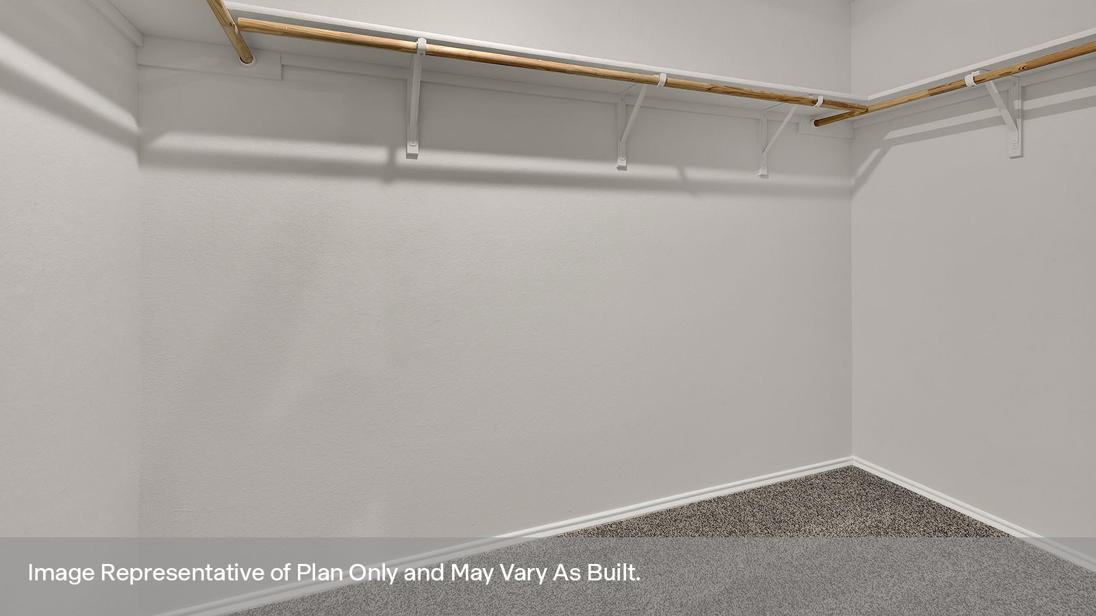 Main bedroom closet with carpeting and wooden shelving.