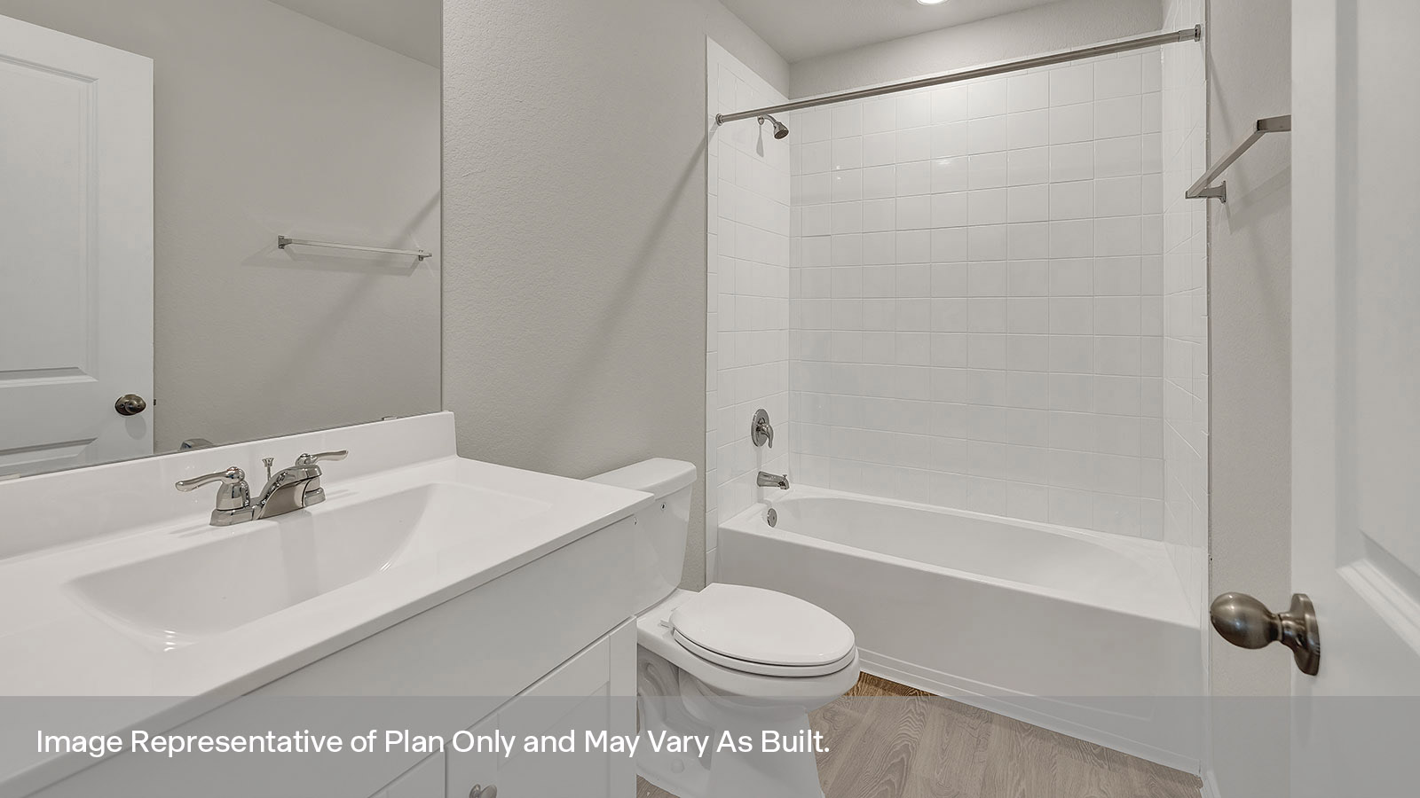 Hall bathroom with vanity, toilet, and tub with tile surround.