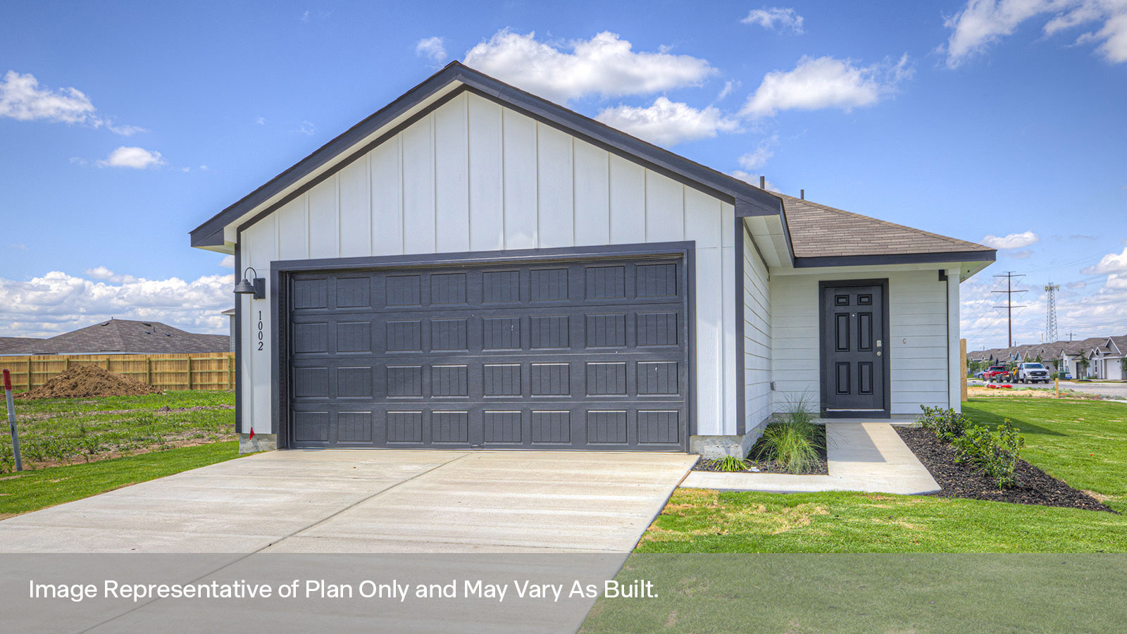 Single-story farmhouse with 2 car garage.