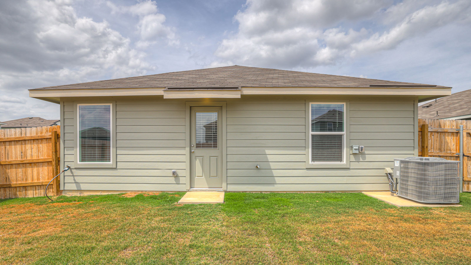 Single-story farmhouse with 2 car garage.