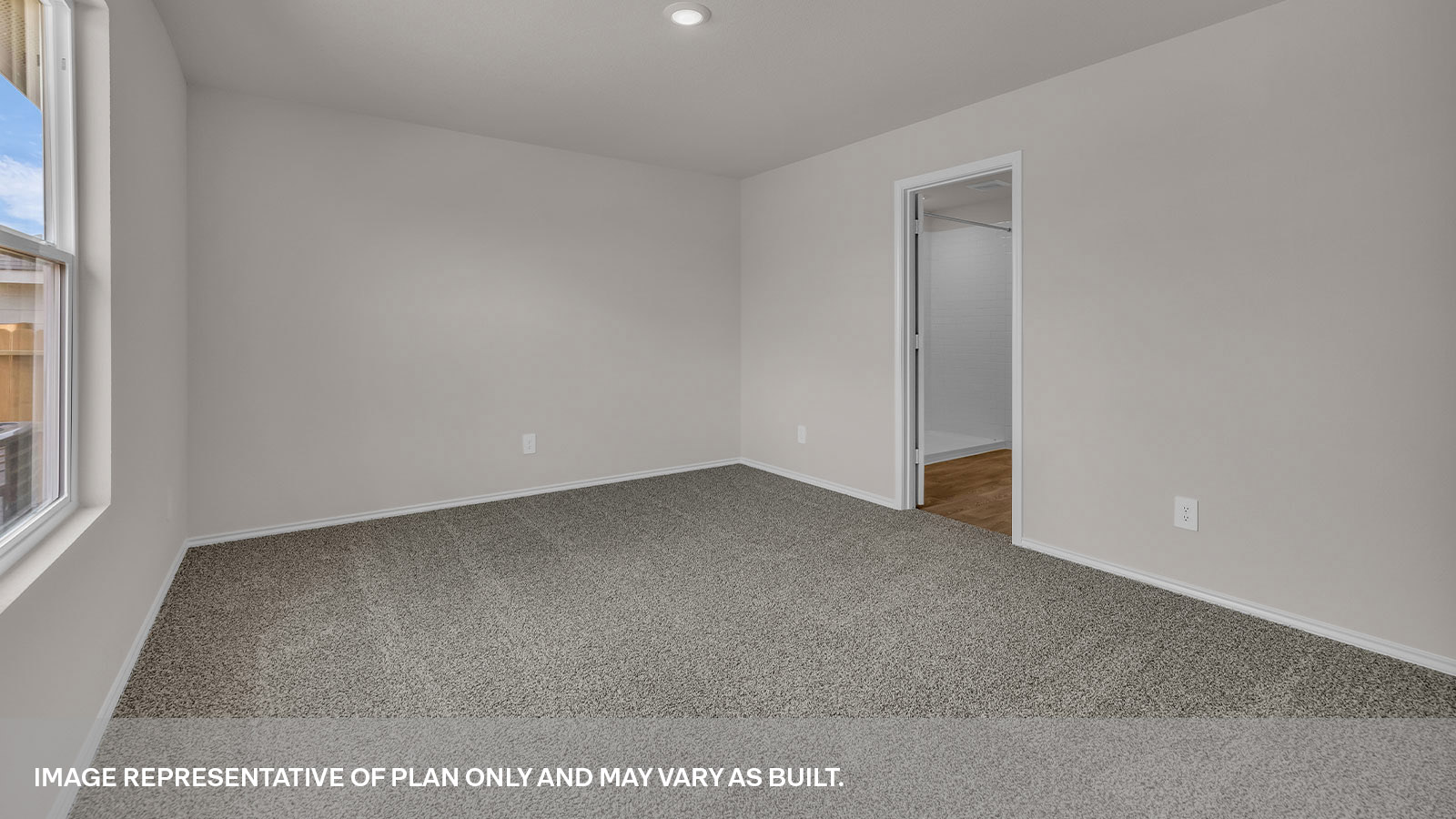 Main bedroom with carpeting and bathroom entry.