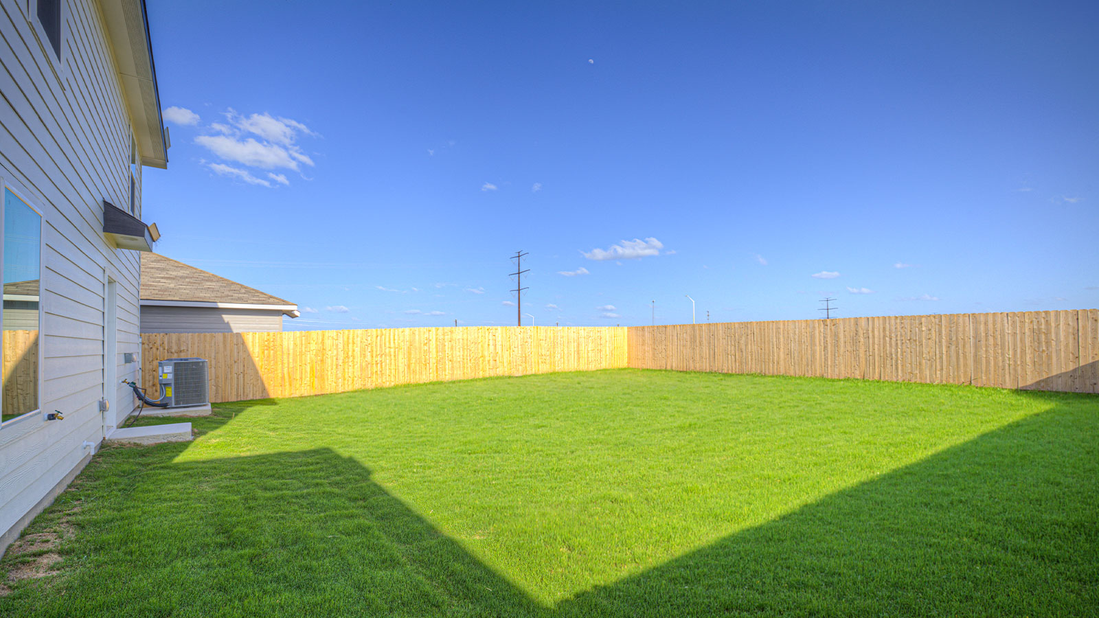 Sodded backyard with privacy fence.