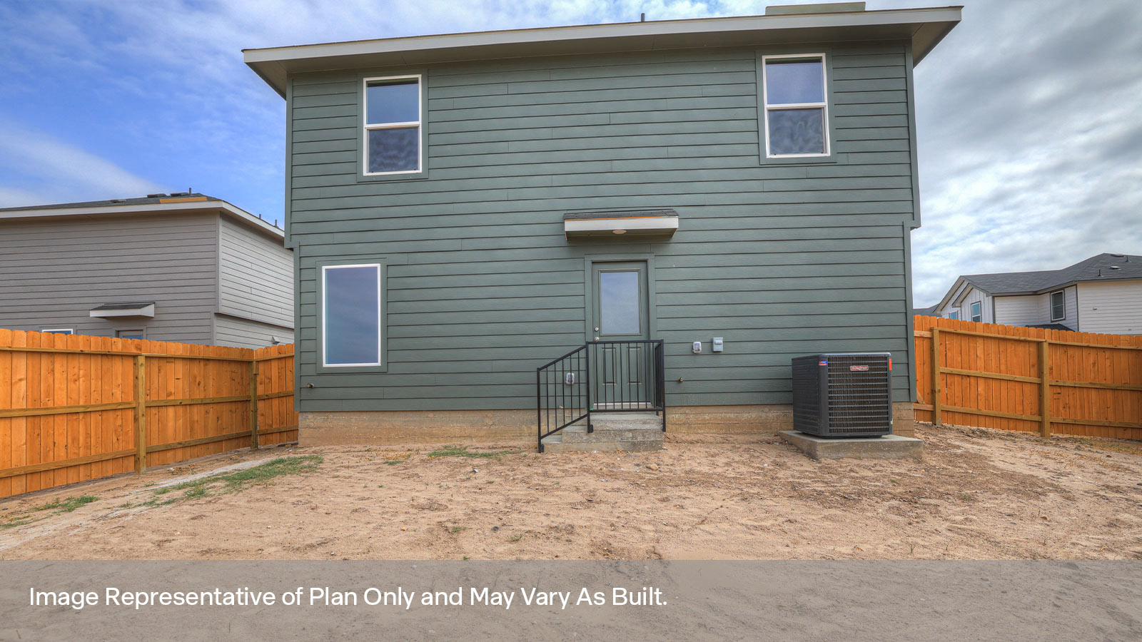 Backyard patio with sod and privacy fence.