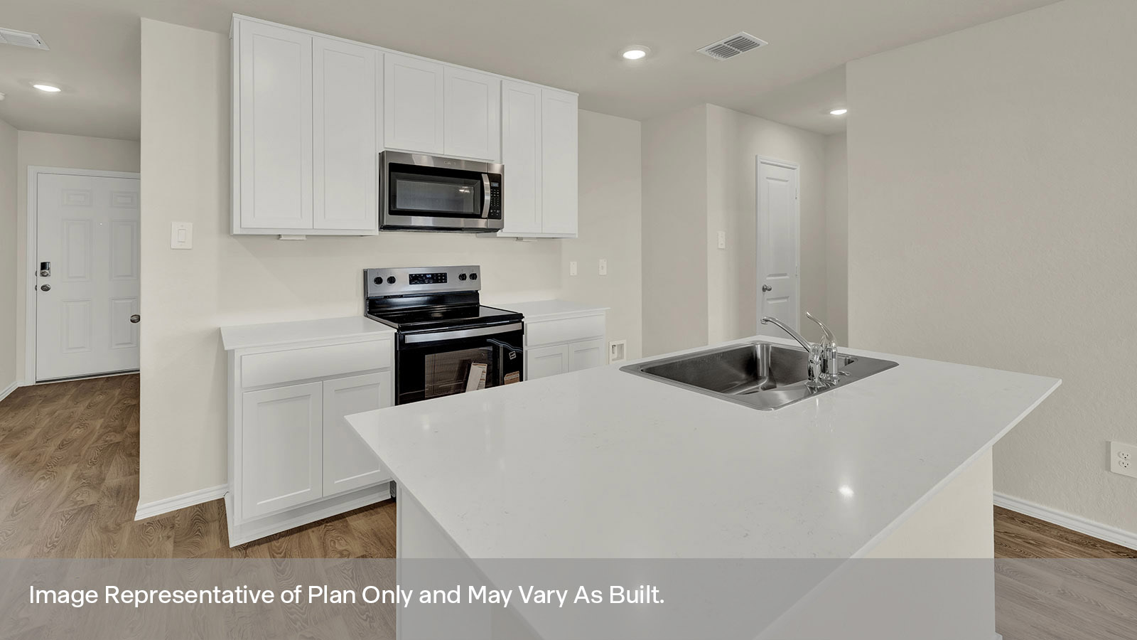 Kitchen with quartz countertops and stainless steel appliances.